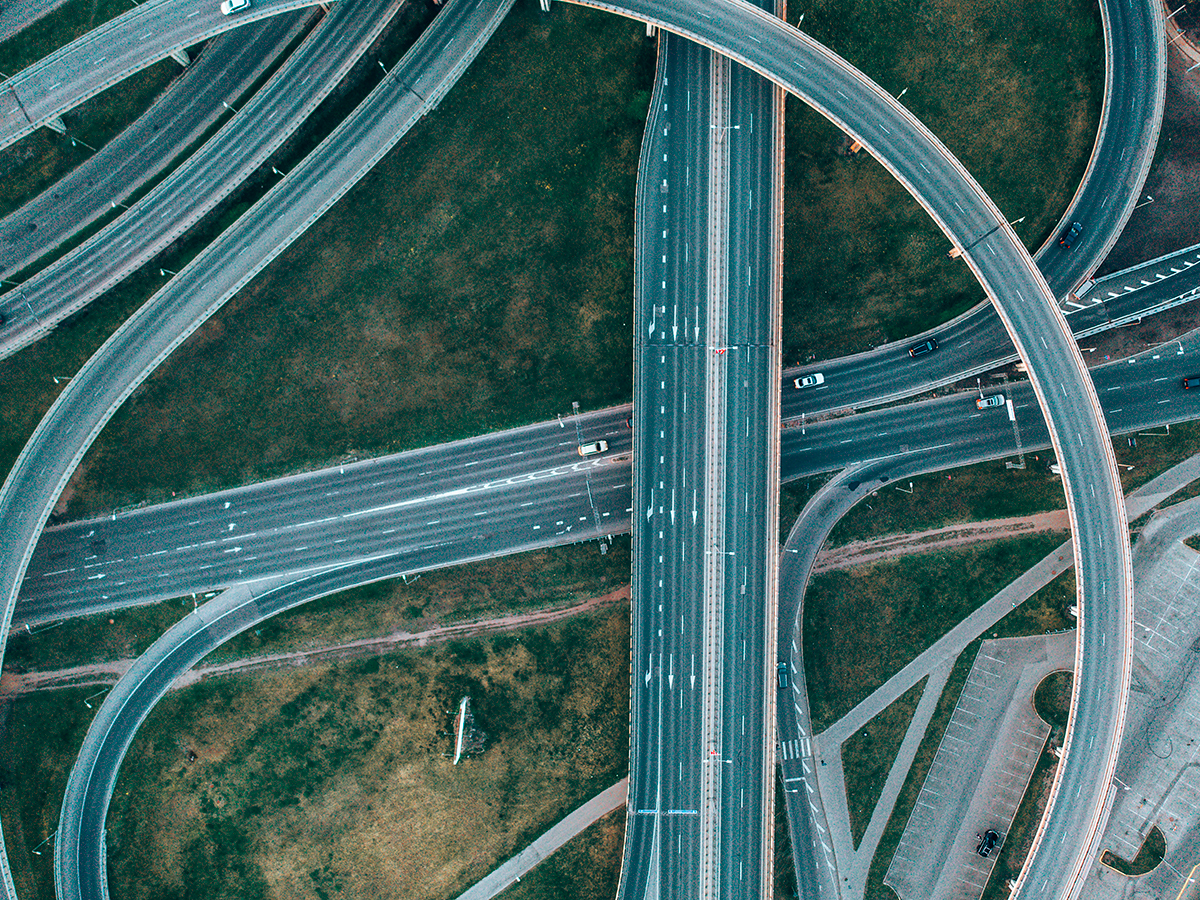 Aerial view of curved motorways crossing over each other at a large interchange